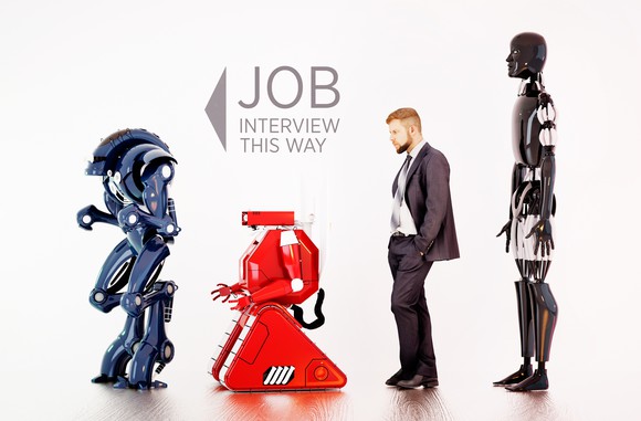3 robots and a man waiting for a job interview