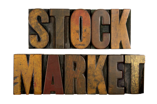 Image of the words Stock Market carved in wood.