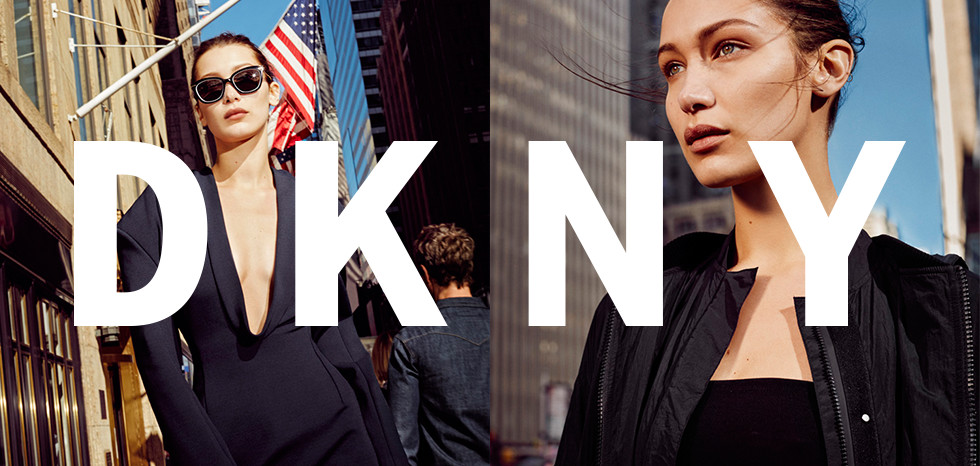 An ad for DKNY featuring two women on the streets of a city.