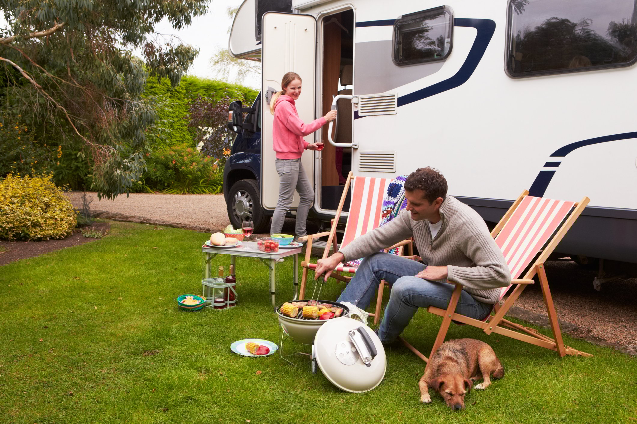 Family grilling in front of an RV