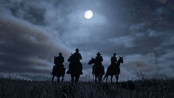 Screenshot of Red Dead Redemption 2 game depicting dark silhouette against a moonlit sky of four cowboys riding horses.