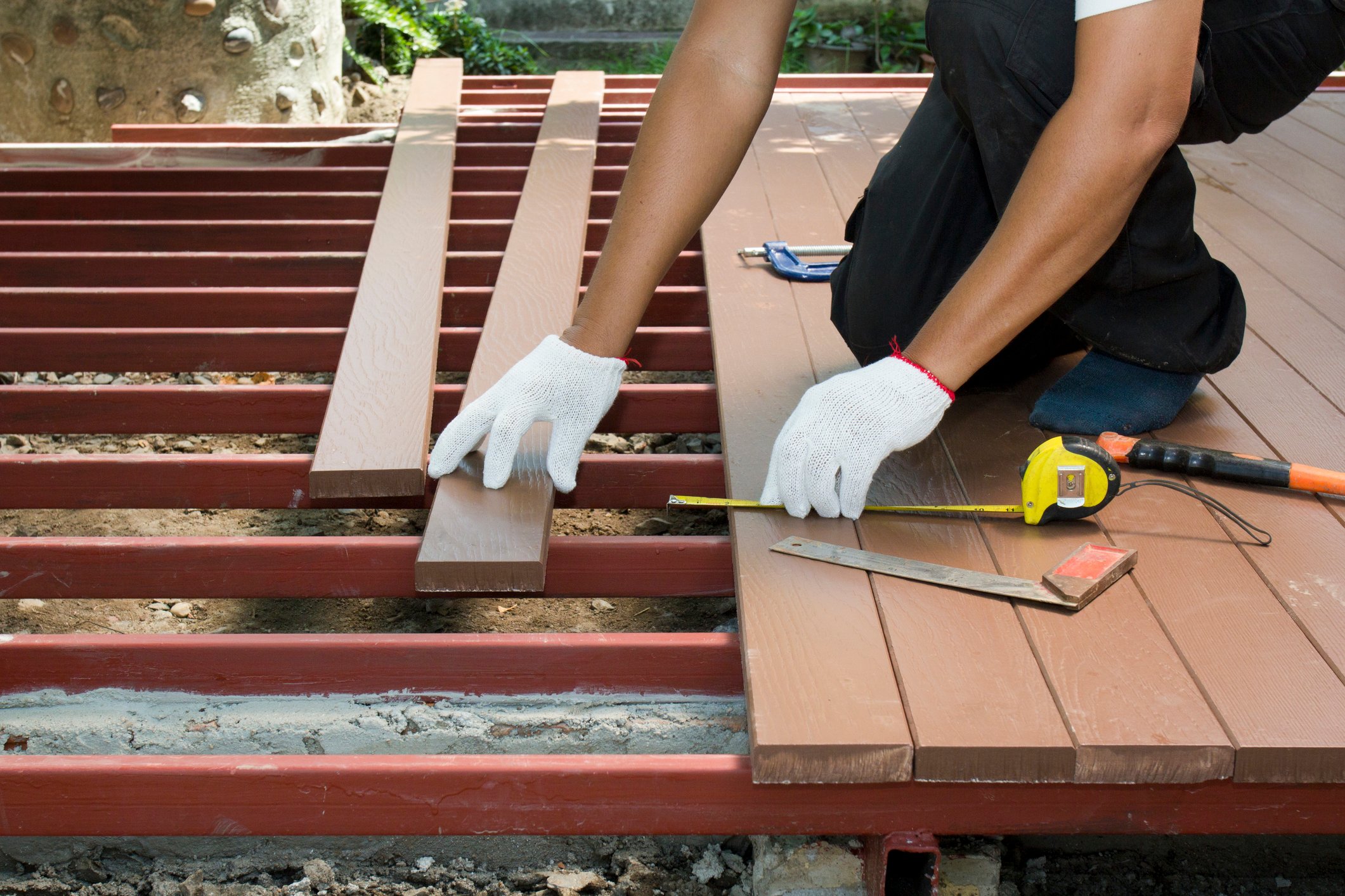 Worker installing wood decking.