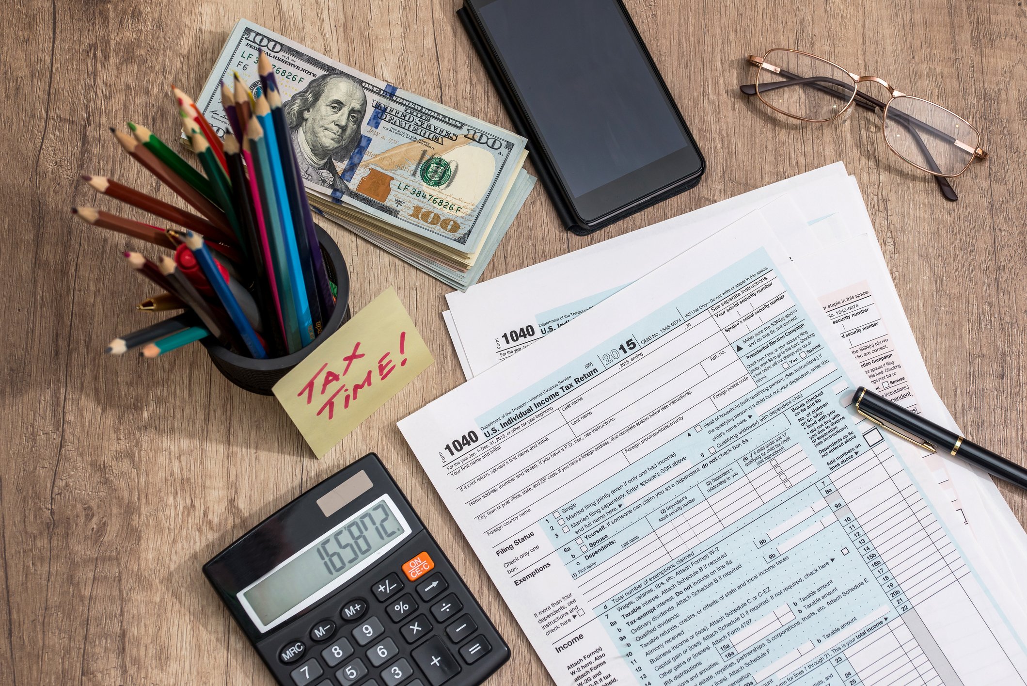 Tax forms, calculator, and various desk equipment.