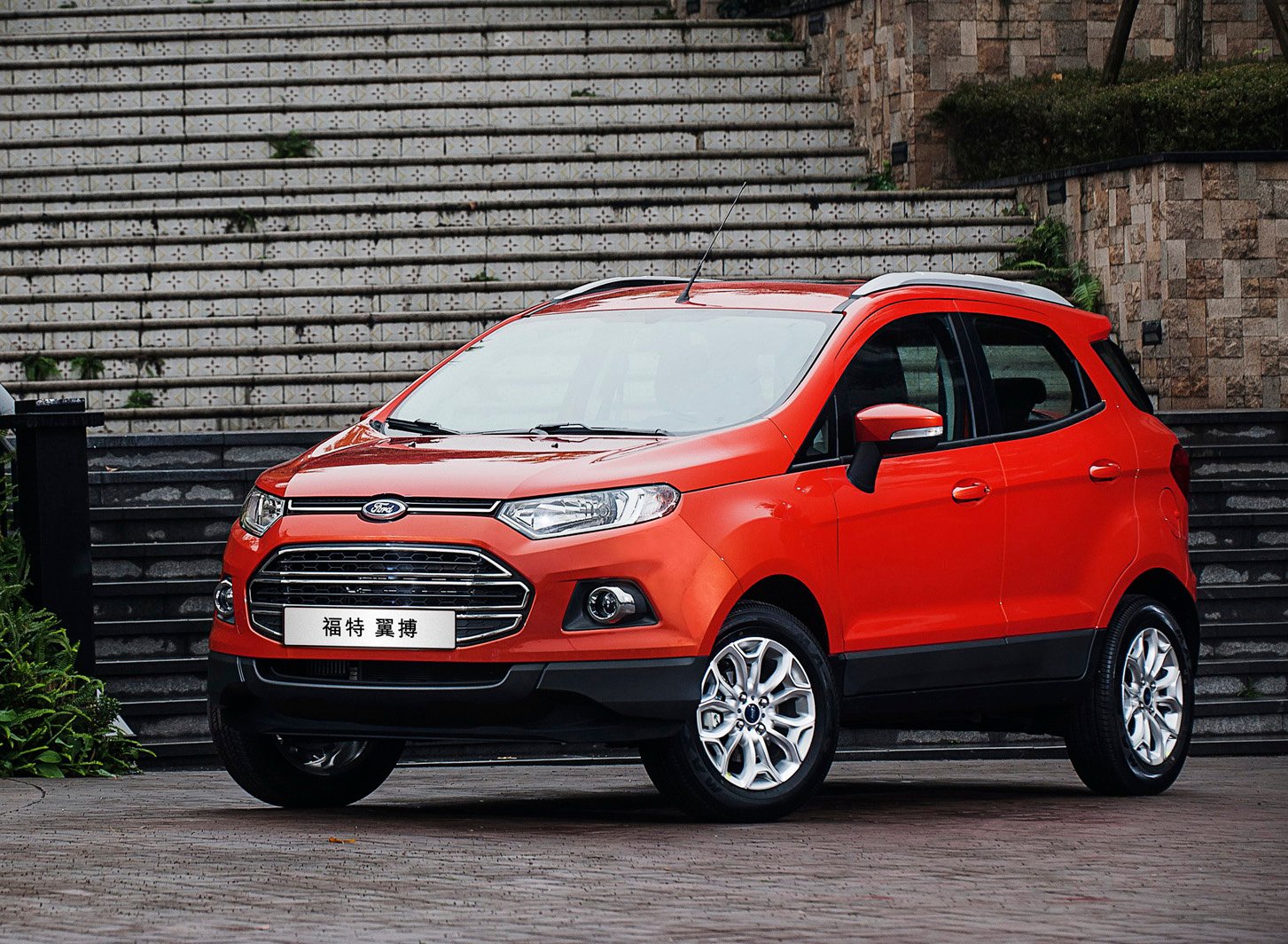 An orange Ford EcoSport SUV with Chinese license plate.