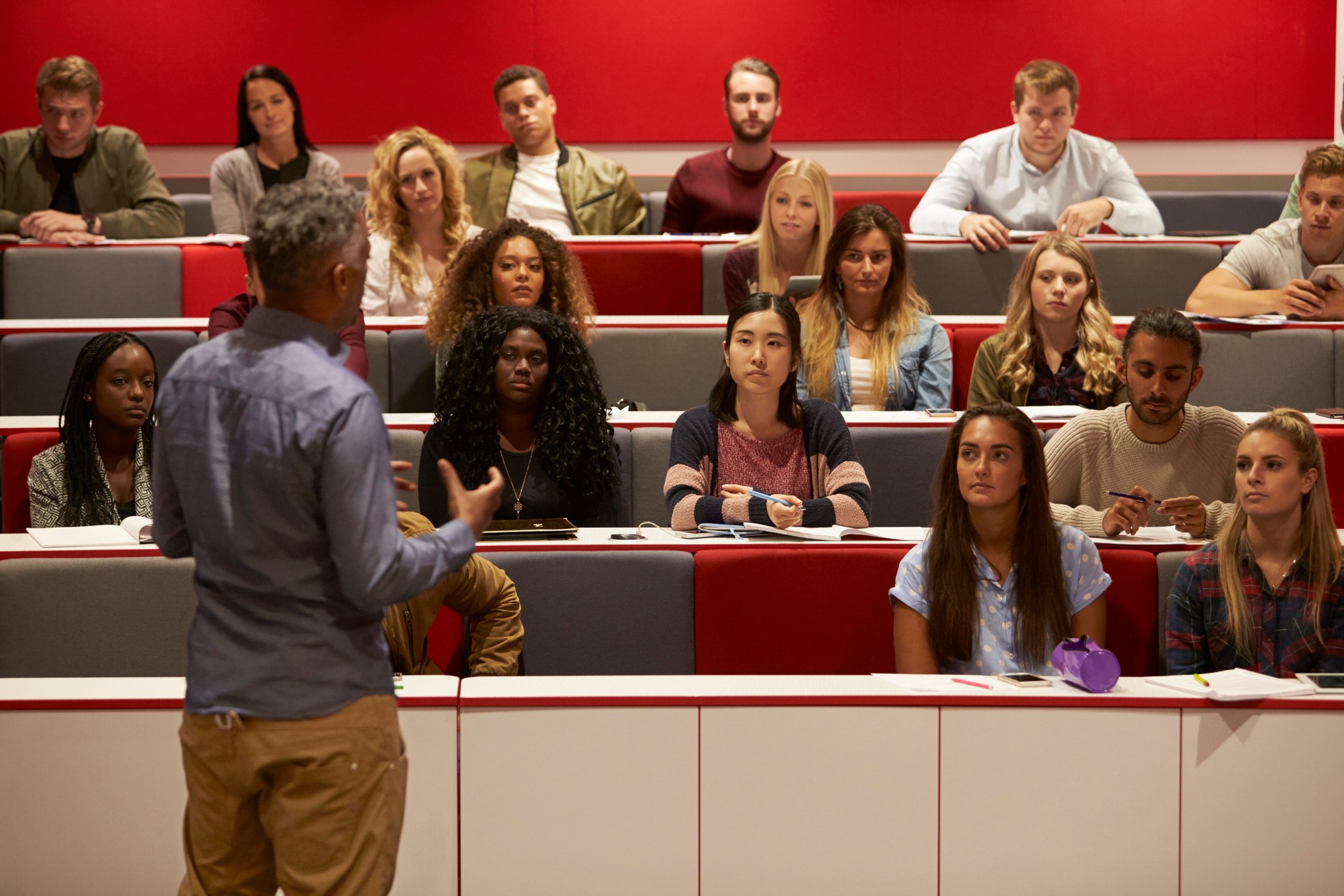 Professor giving a lecture in a college classroom. 