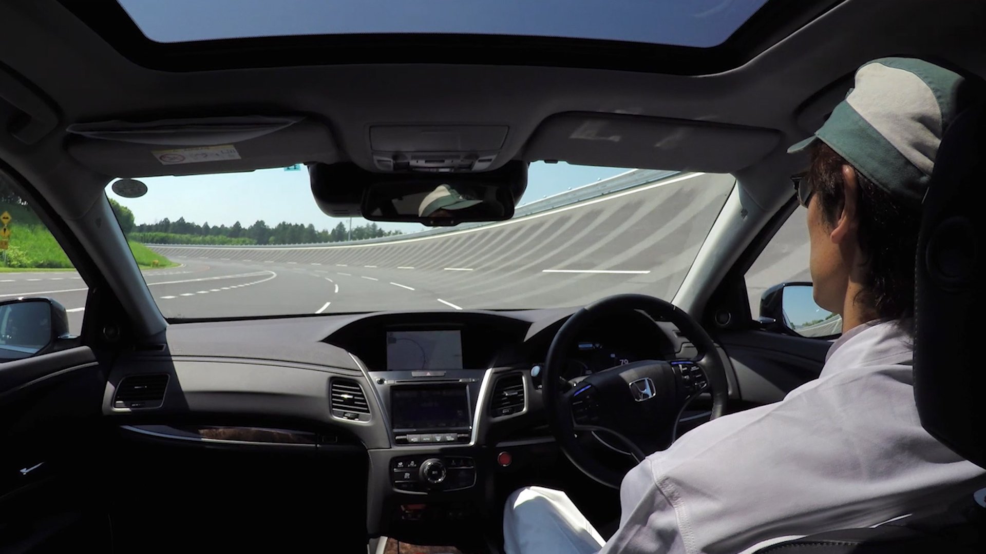 The view from the back seat of a Japan-market Honda Legend sedan in a self-driving test on a race track.