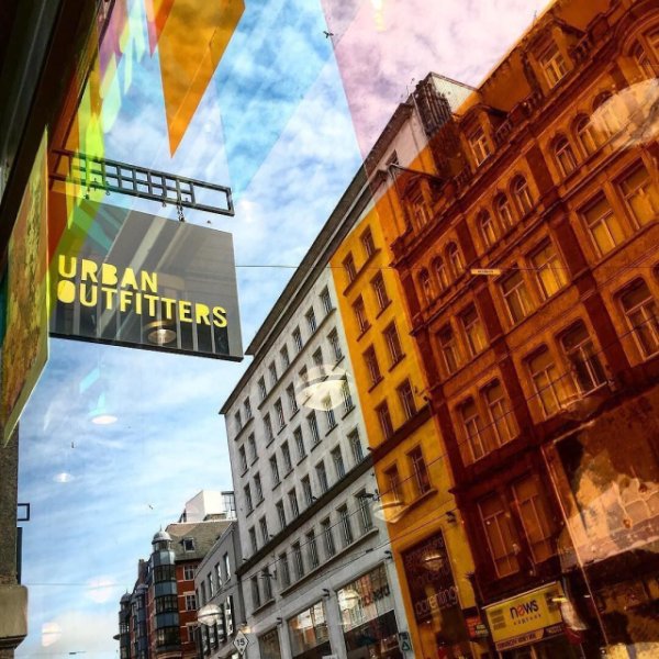 An Urban Outfitters sign on a city street
