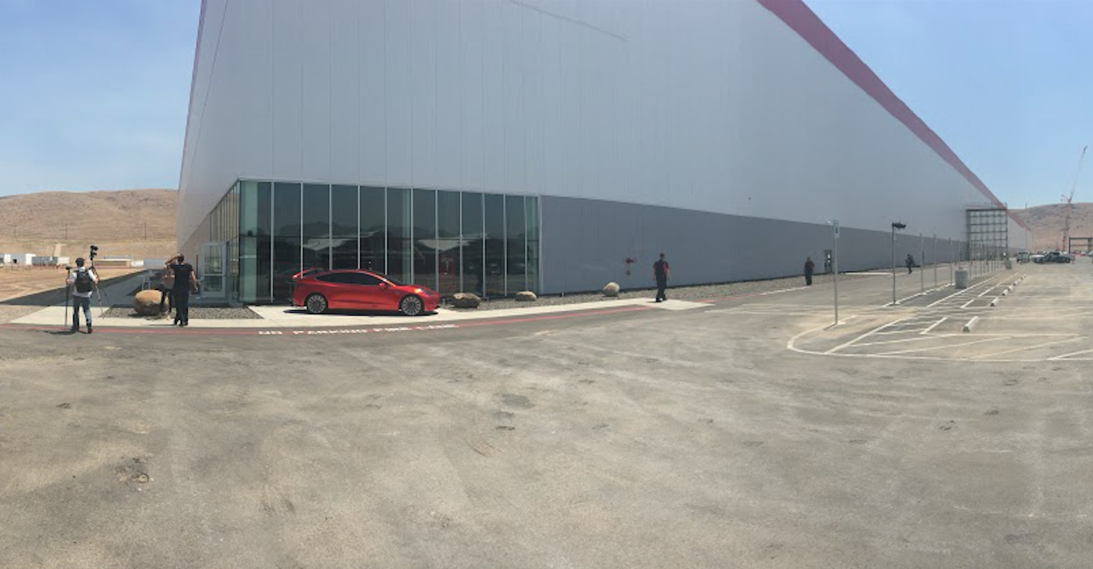 Tesla Gigafactory with Model 3 outside