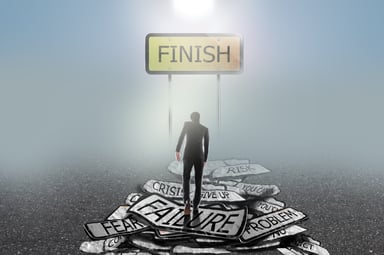 Man walking through failure to finish line