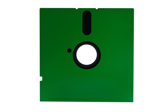 A 5 1/4-inch floppy disk with a green sleeve.