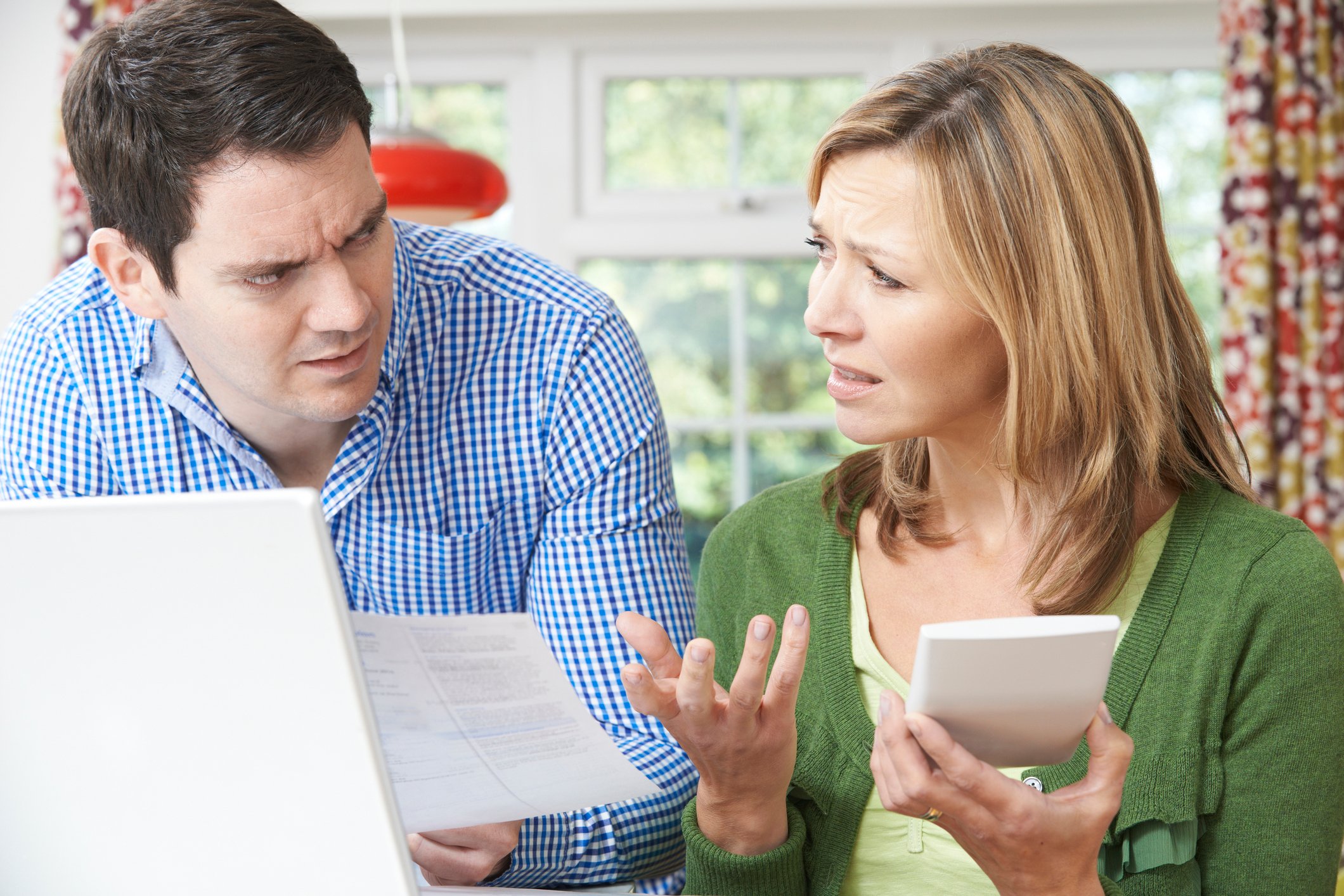 Worried couple discussing bills