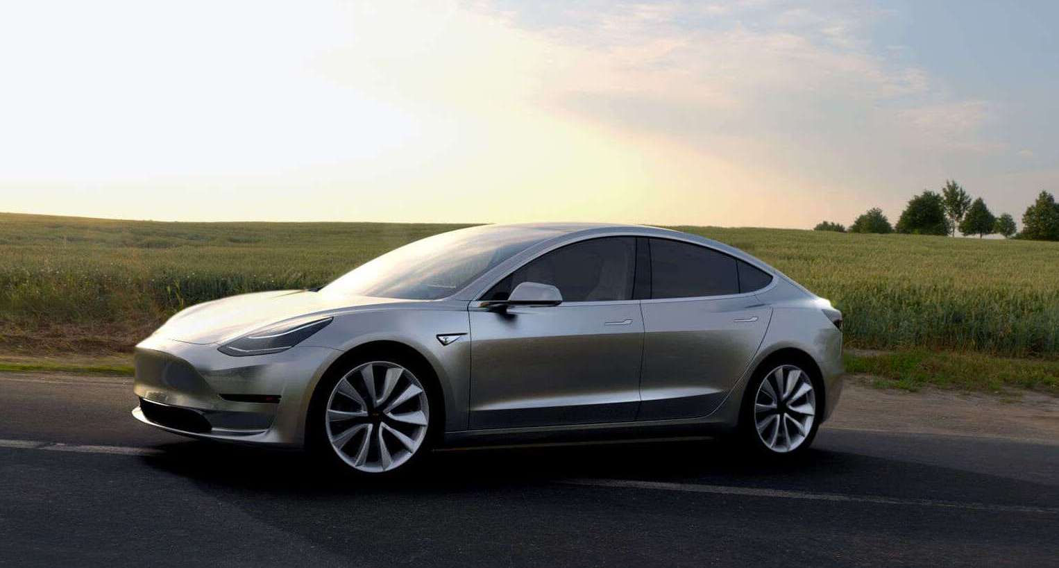 A Tesla Model 3 shown parked with a field in background.