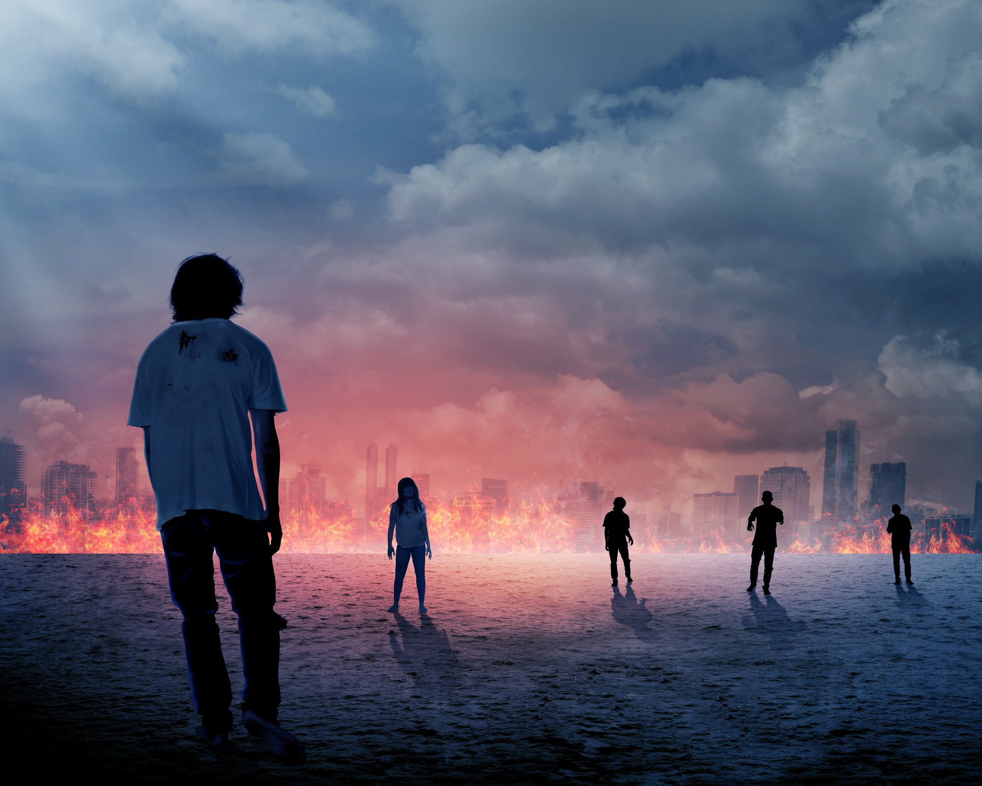 Zombies walking into a burning city.