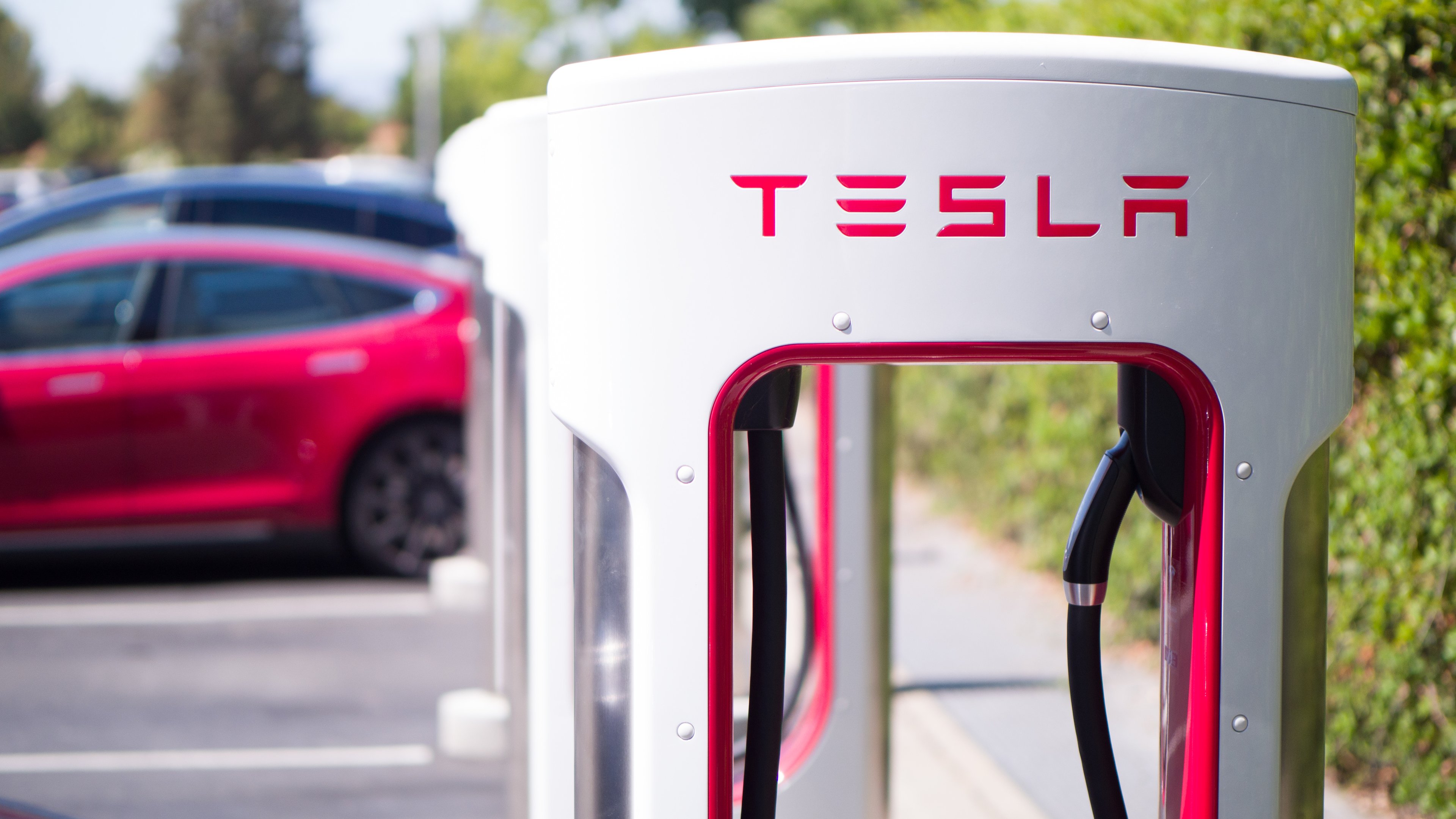 Tesla vehicles at a Tesla Supercharger location