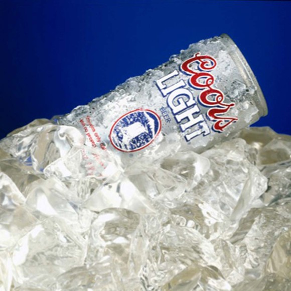 A can of Coors Light sitting on top of a pile of ice.
