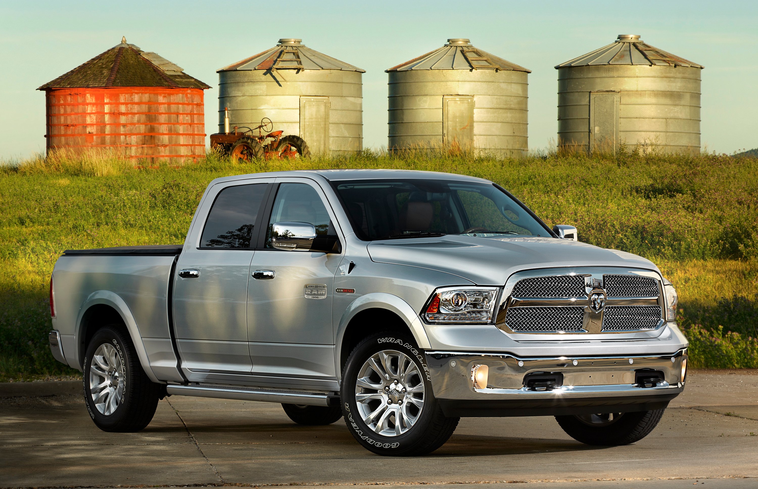 A silver Ram 1500 EcoDiesel pickup in a farm setting.