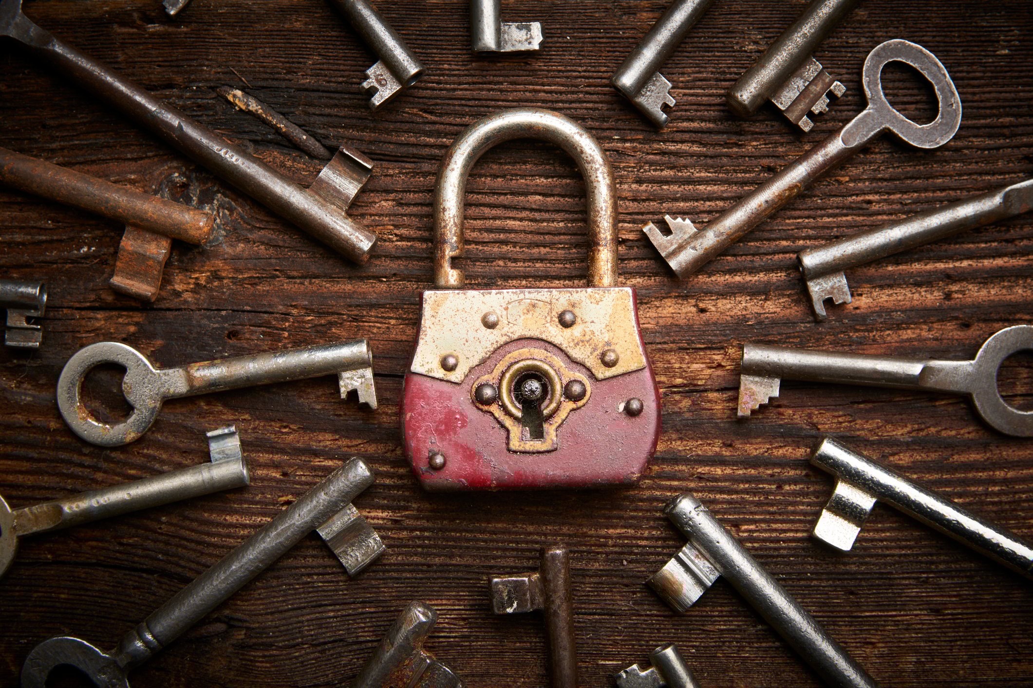 A lock surrounded by many keys
