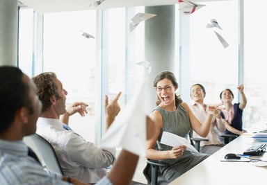 Business people throwng paper airplanes