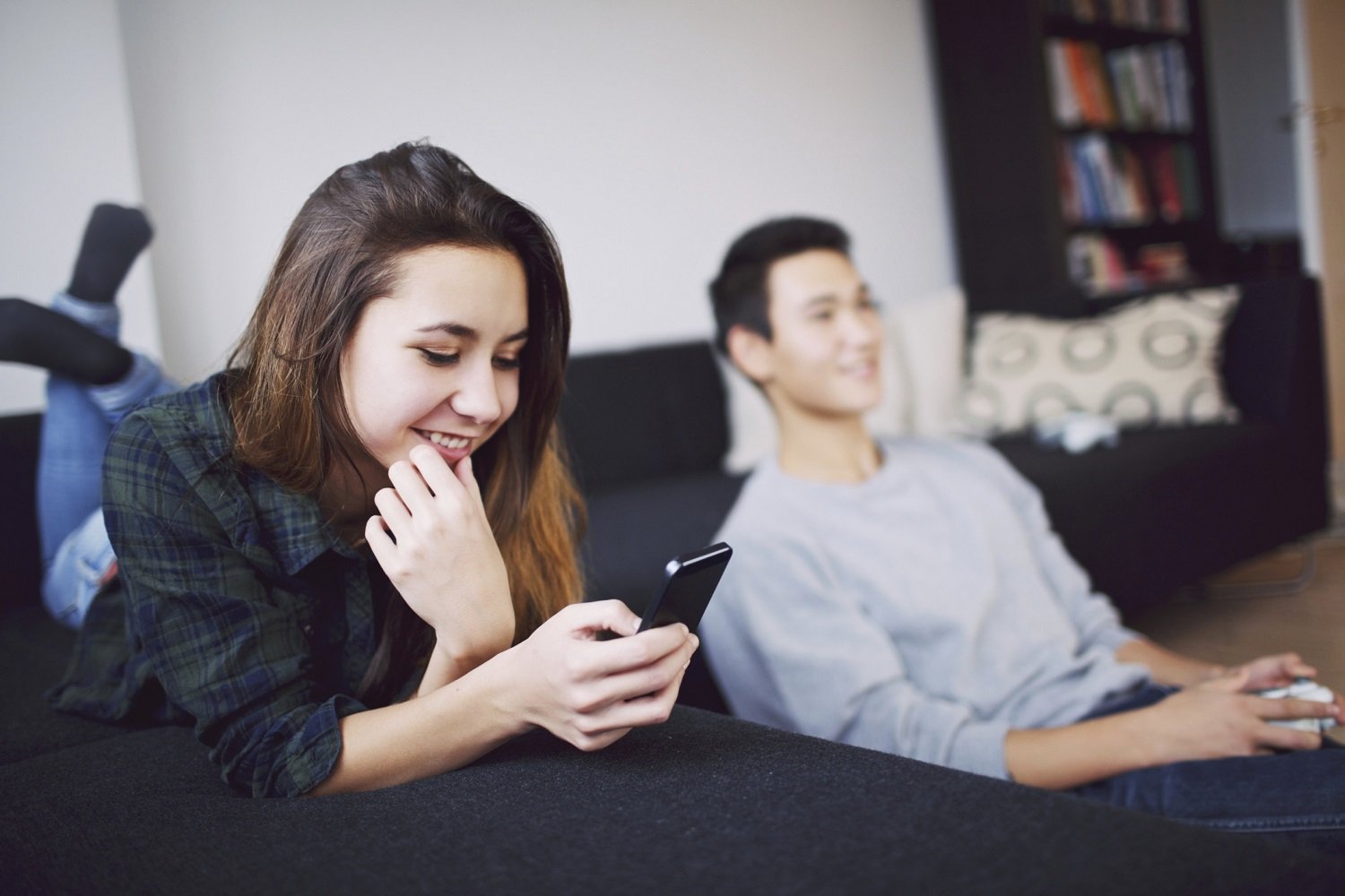 Young man and woman using smartphones to surf the internet.