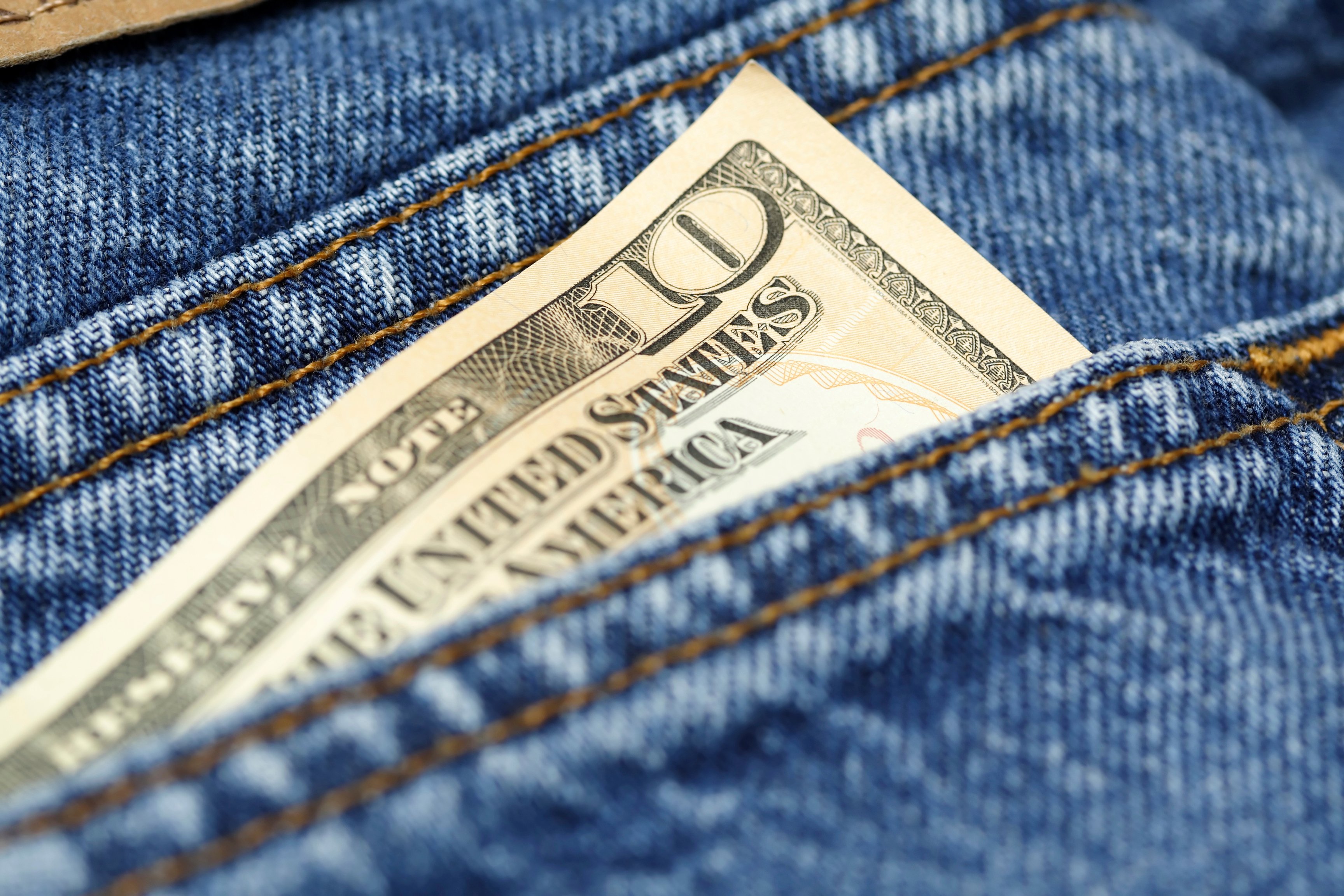 $10 bill in jeans pocket.