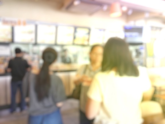 People waiting in line at a fast food restaurant