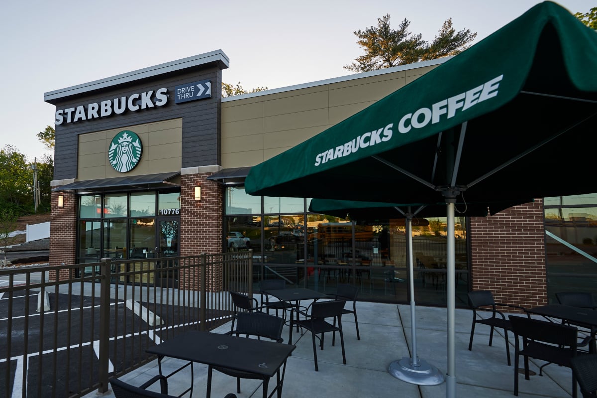 The exterior and patio area of a Starbucks store.
