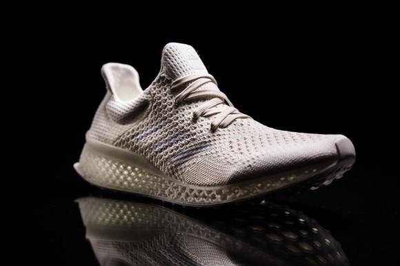 One of Adidas' new, futuristic sneakers against a black background.
