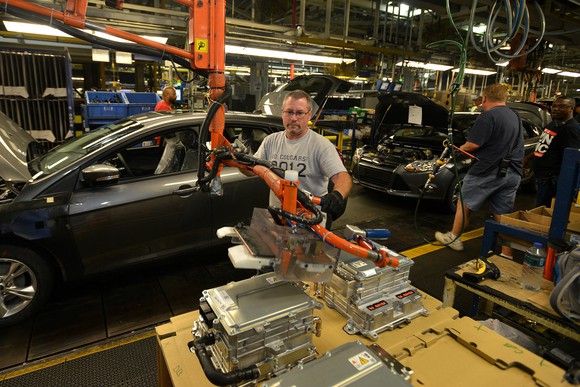 Workers assemble Ford Focuses on the assembly line at Ford Michigan Assembly Plant in Wayne, Michigan, in this 2013 file photo.