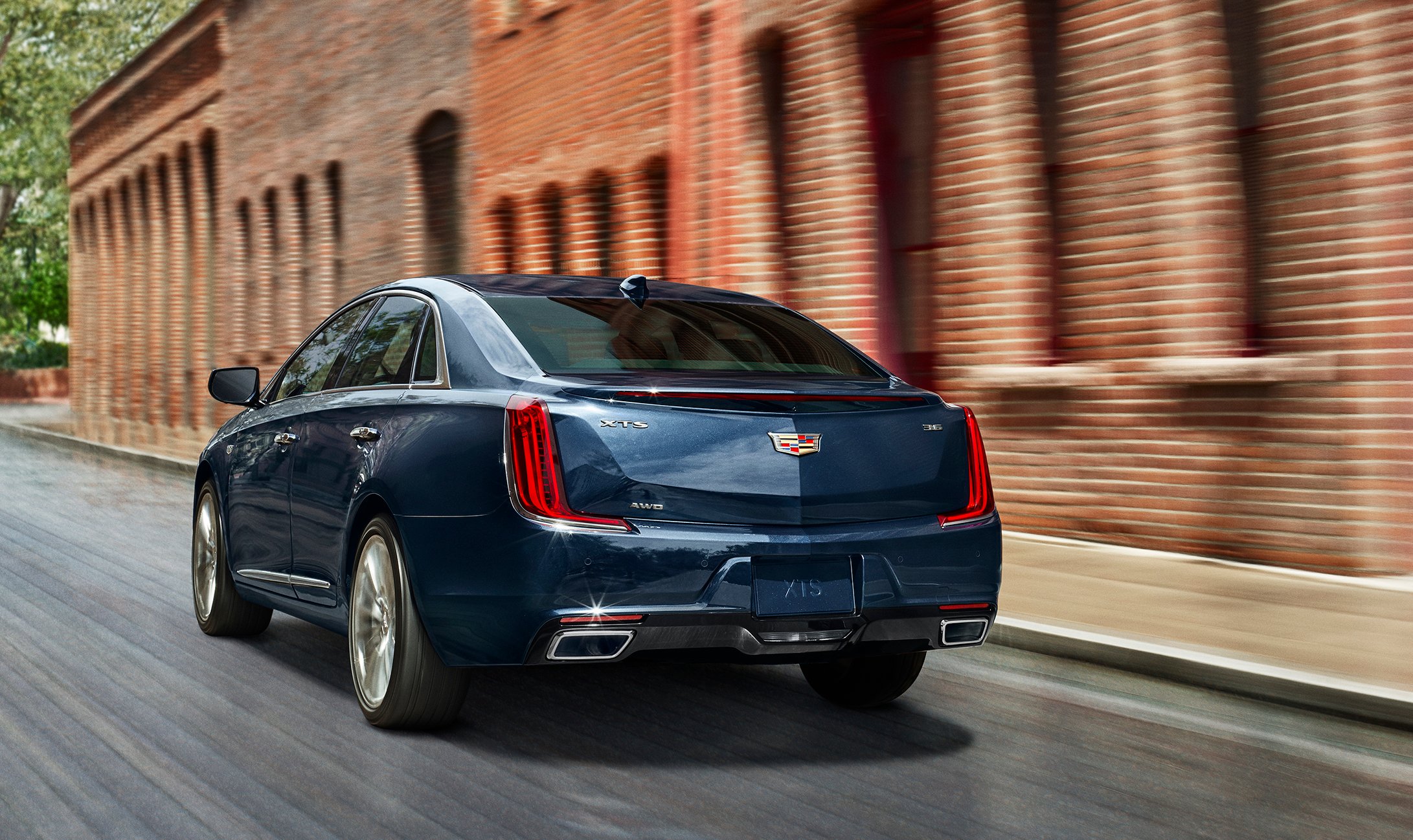 The 2018 Cadillac XTS, viewed from the rear on a city street