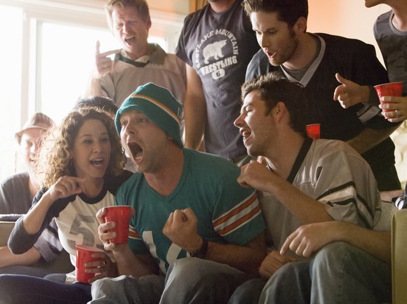 Friends watch football