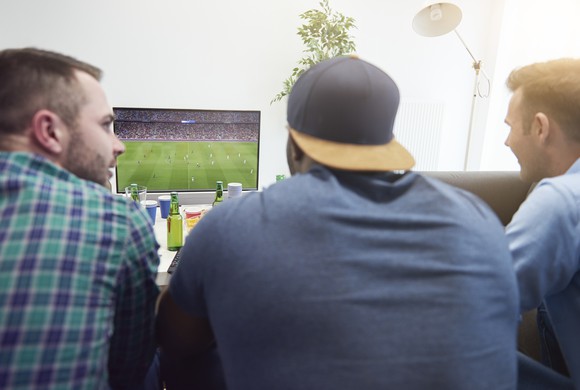 Friends watch a football game