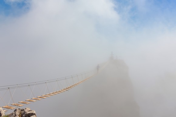 A bridge disappearing into mist