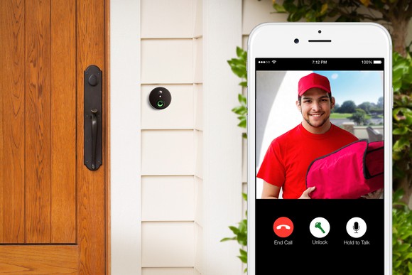 A person views who is at his door using a smartphone.