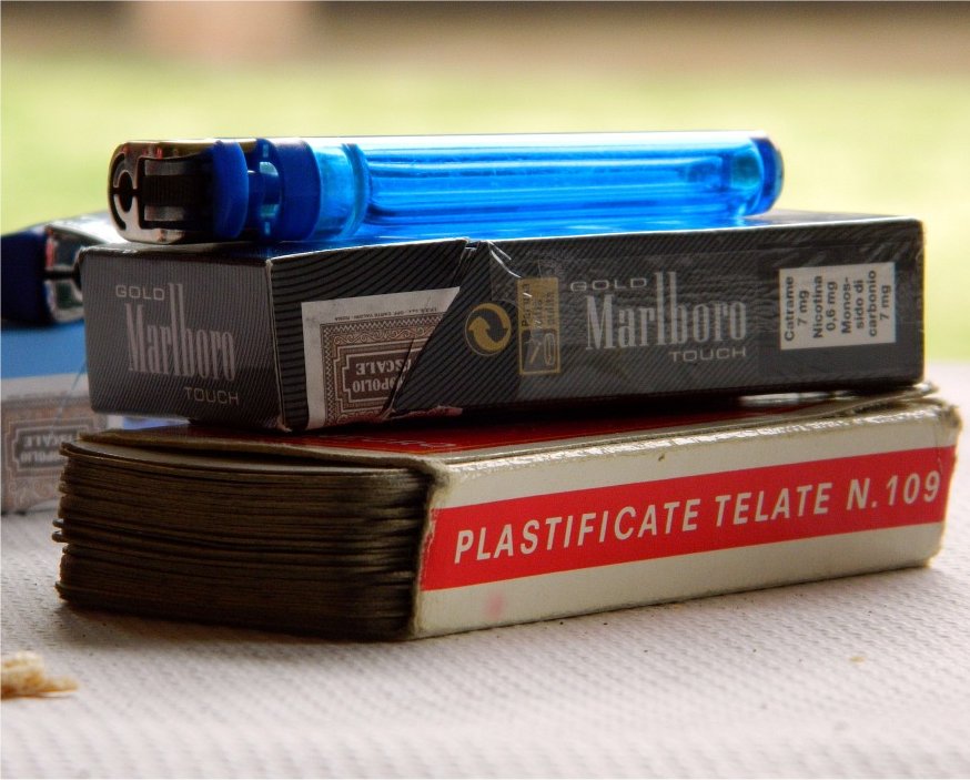 A lighter, pack of Marlboro cigarettes, and playing cards.