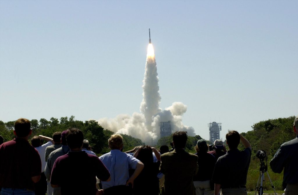 Spectators watch a Delta IV launch.