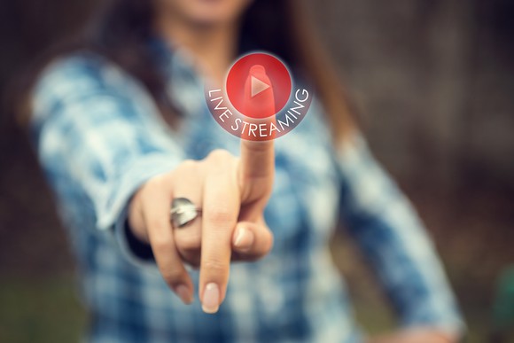A woman presses a "live streaming" button.