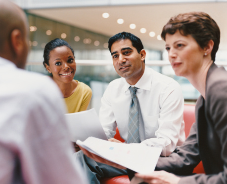 Small group of men and women in an office discussion