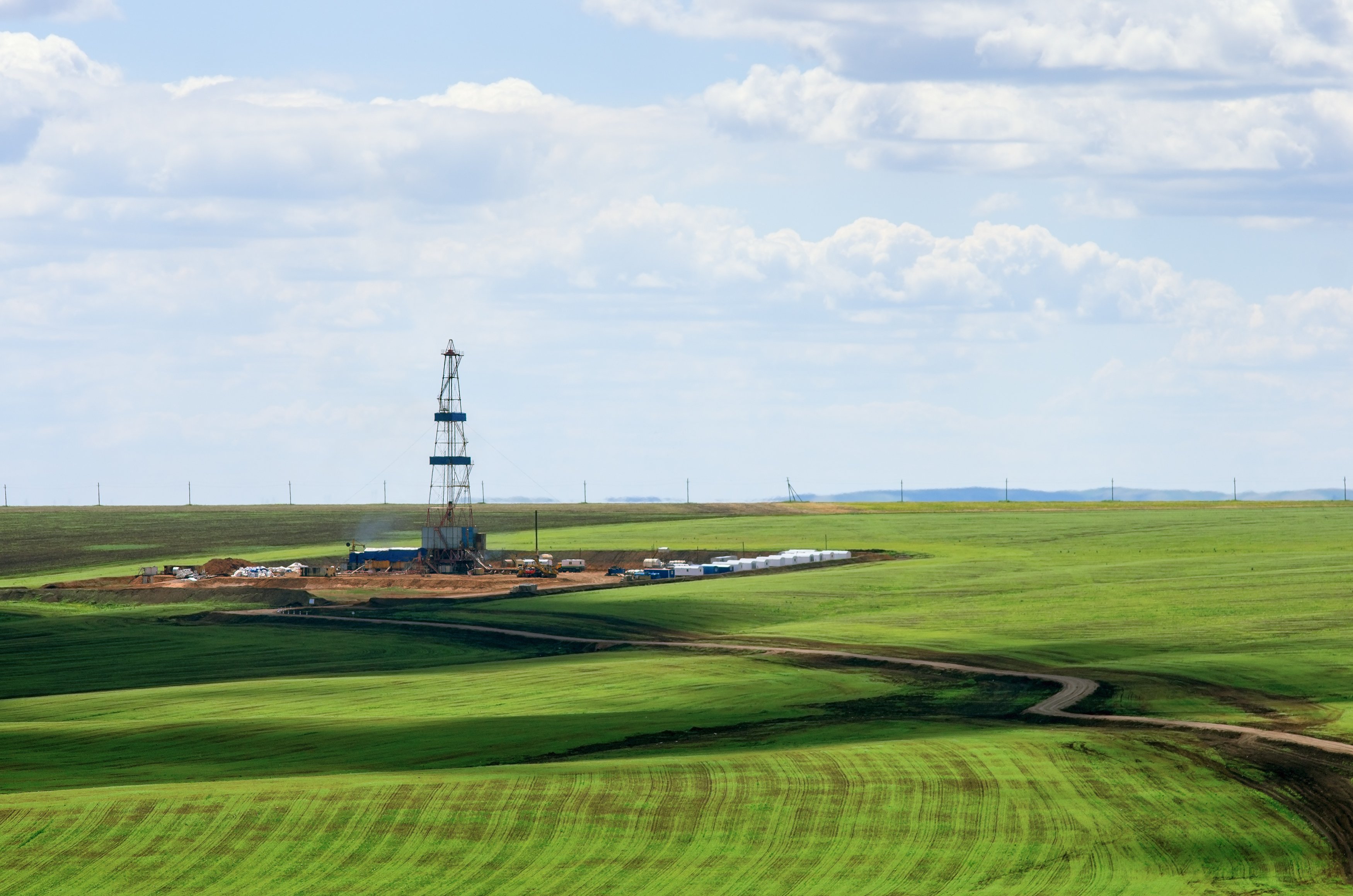 Drilling rig among agricultural fields.