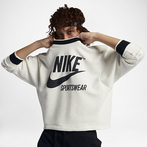 A model pulls a Nike sweatshirt over her face.