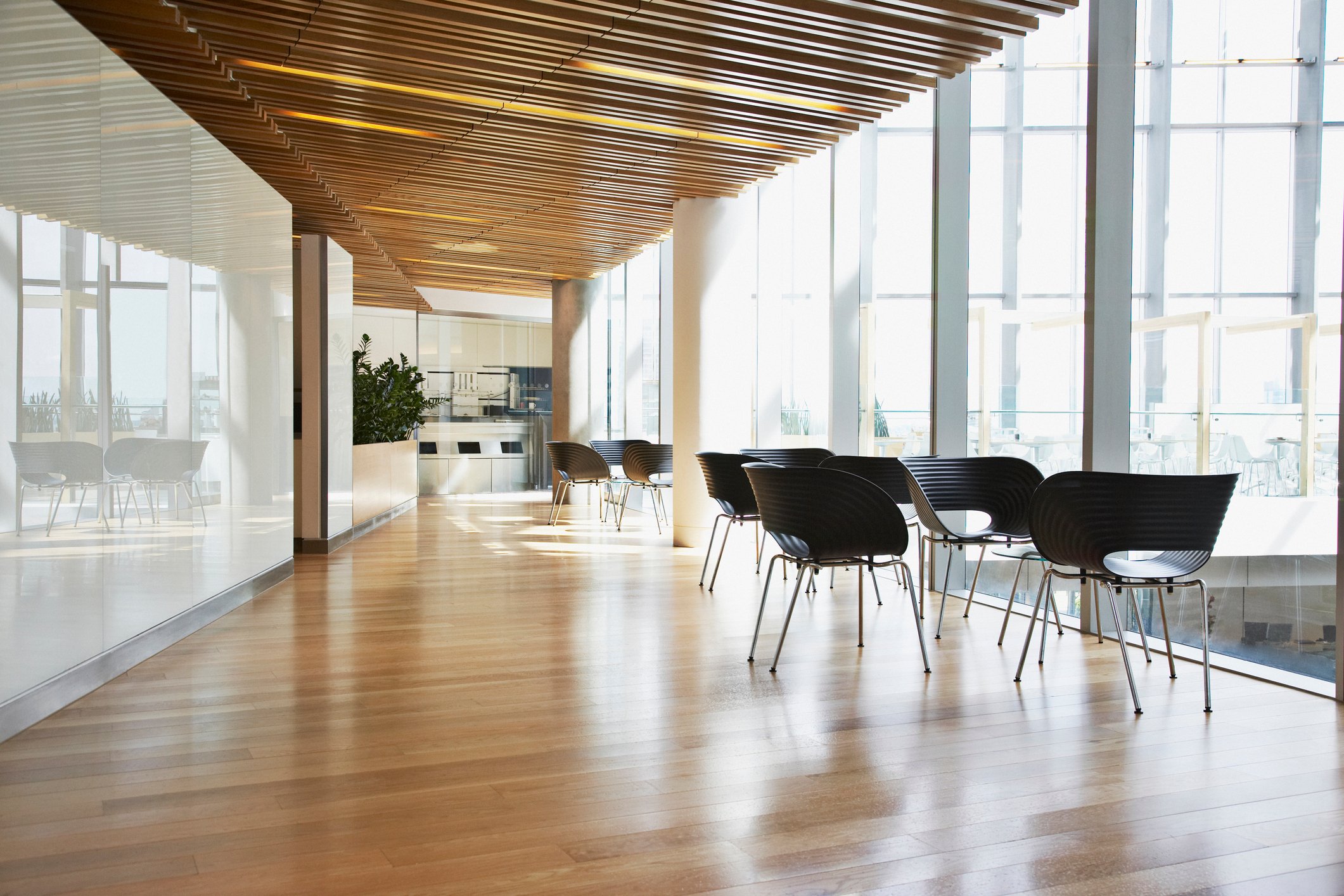 A sleek office hallway with contemporary tables and chairs.