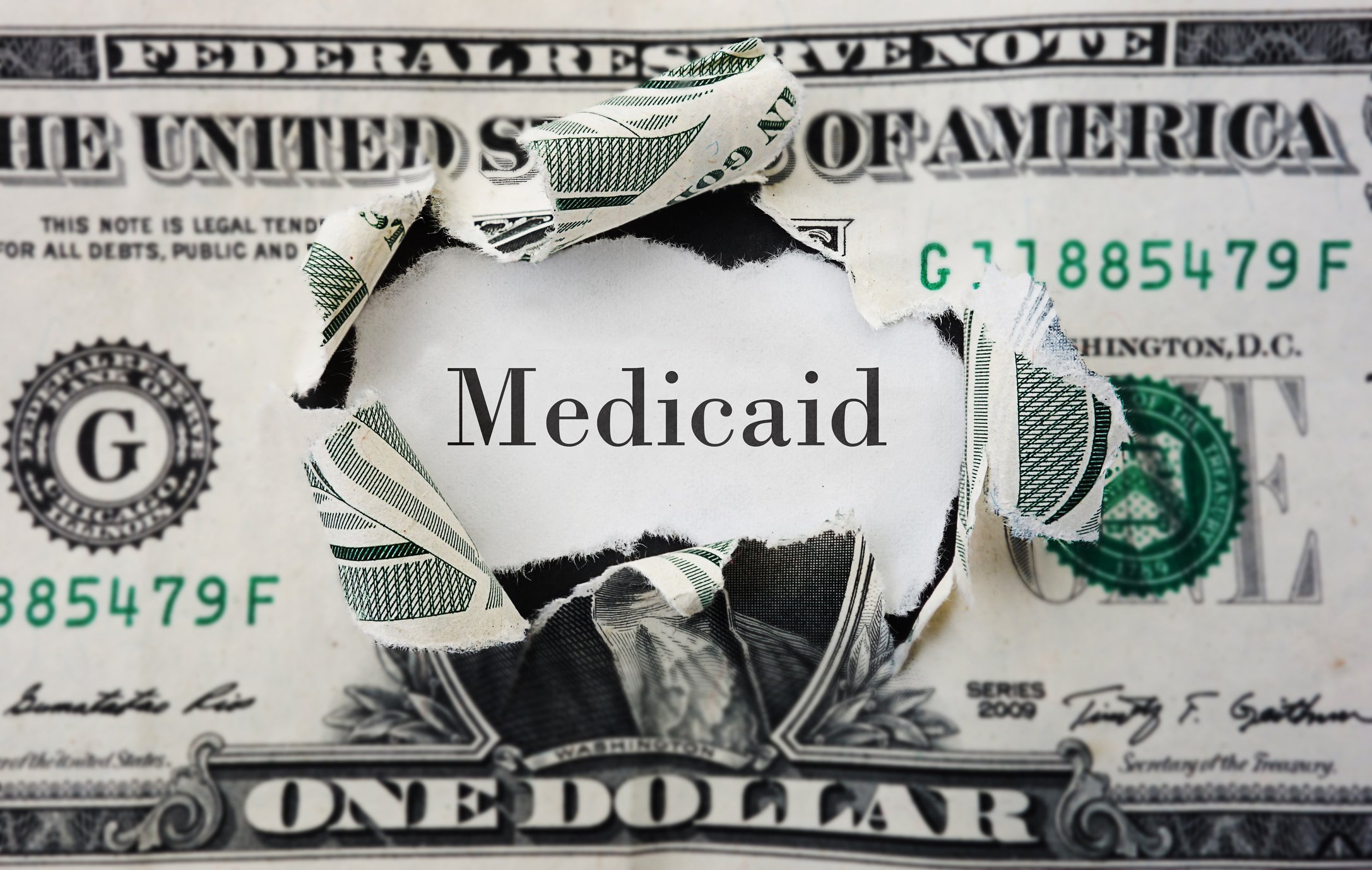 The word Medicaid in place of George Washington's picture on a one dollar bill.
