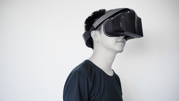 A man with a virtual reality headset on his face.