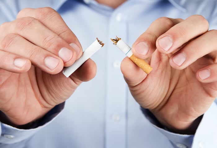 Breaking cigarette in half