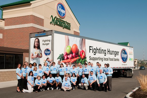 A group of volunteers outside of a Kroger supermarket