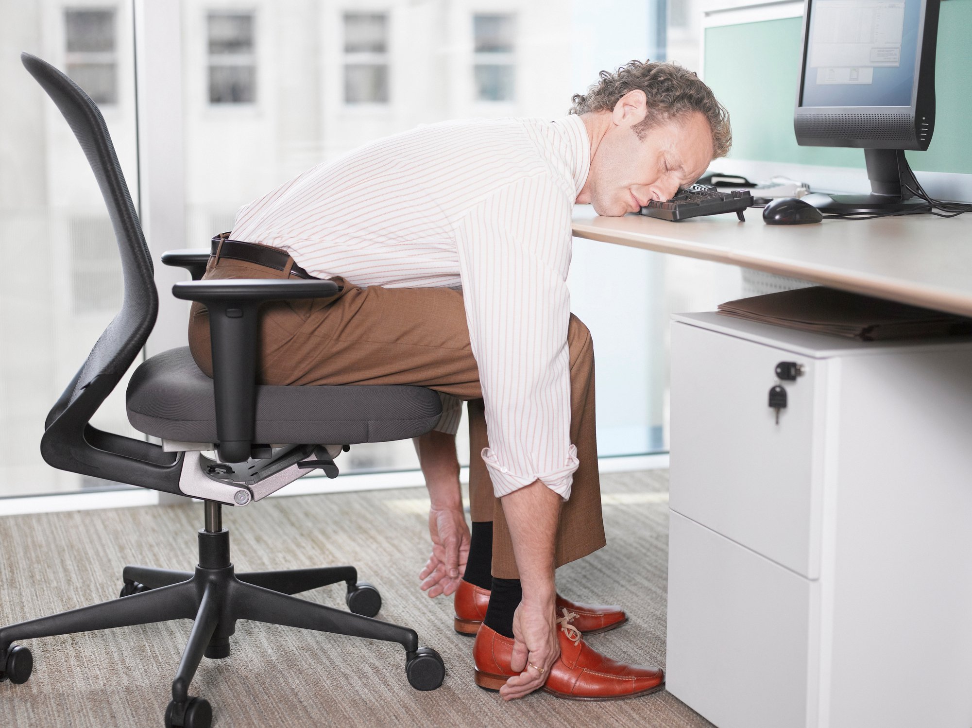 Businessman sleeping at his keyboard