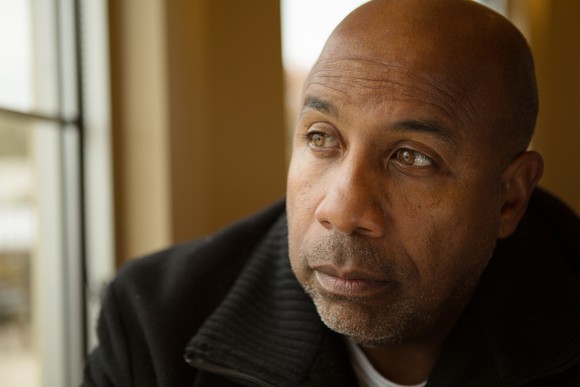 worried man looking out window