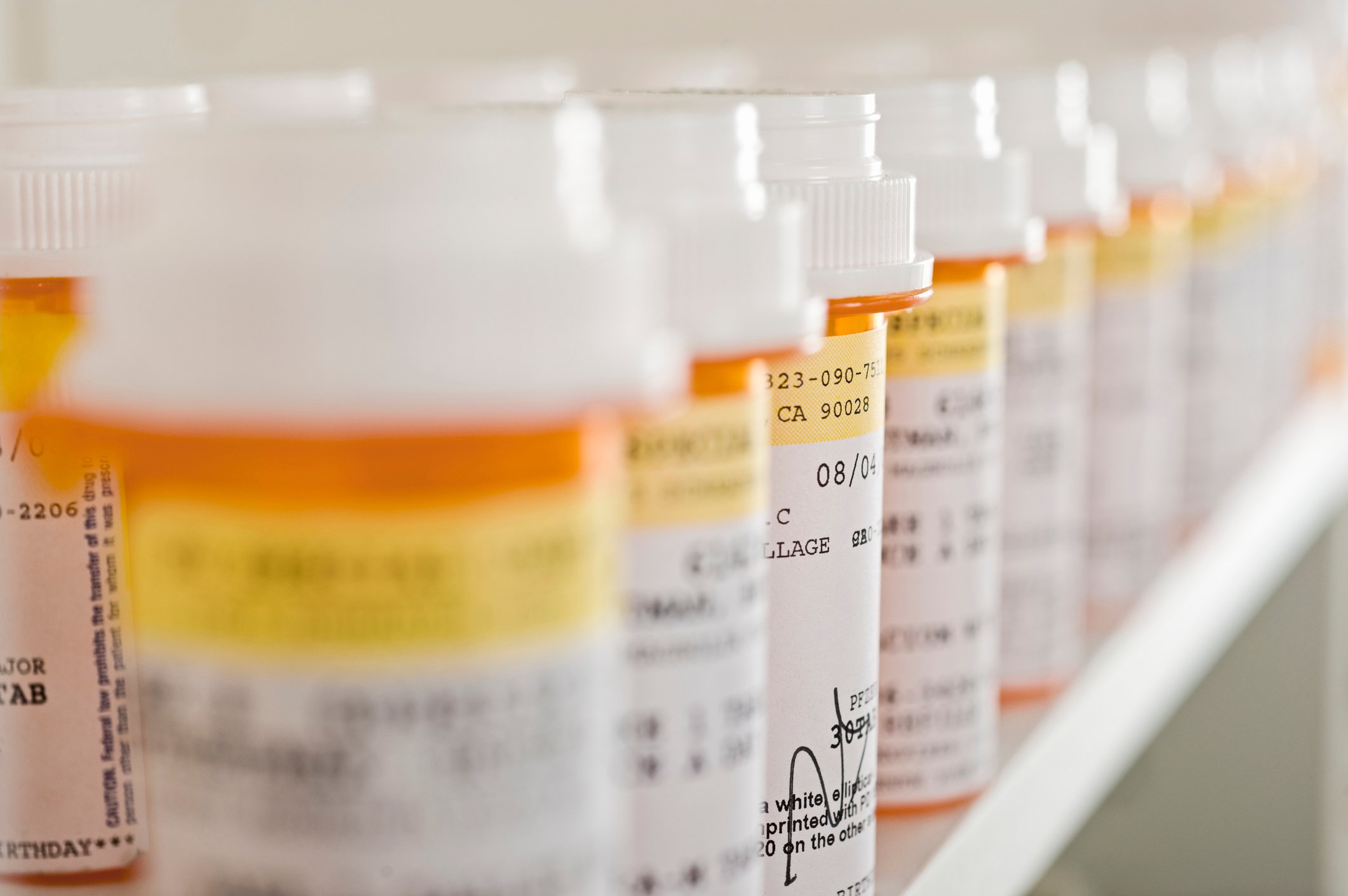 Prescription medicine bottles lined up in a row