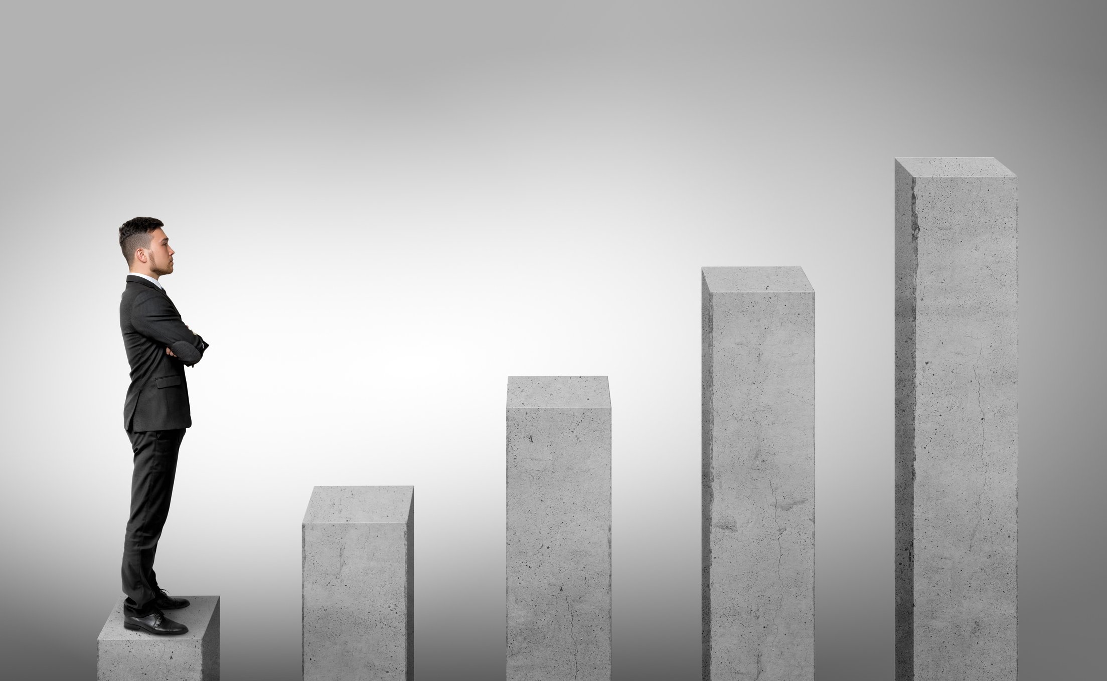 business man looking at growing columns