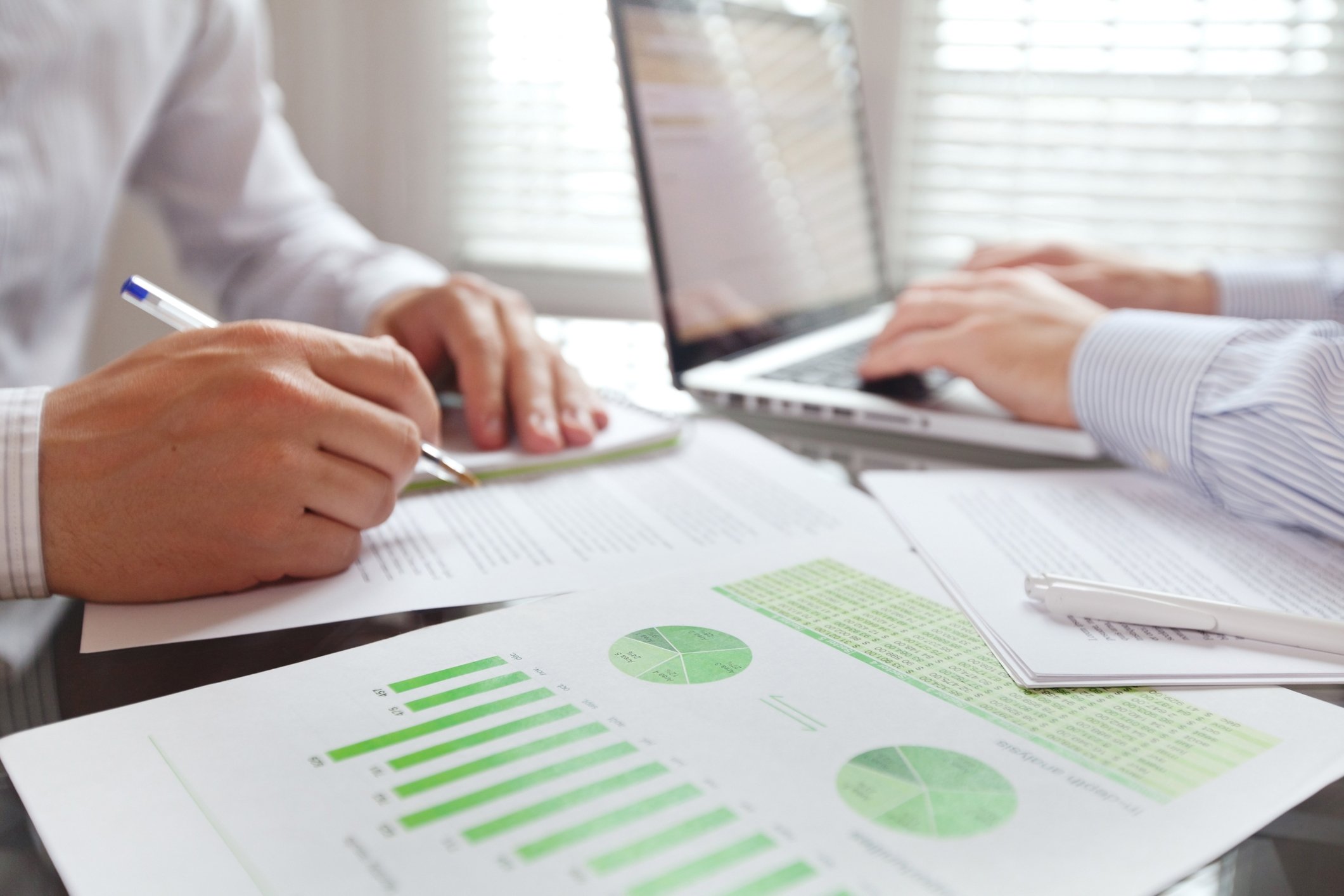 Businessmen doing financial research.