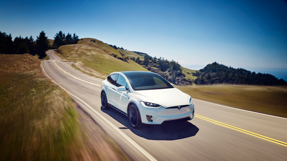 A Tesla Model X driving downhill.